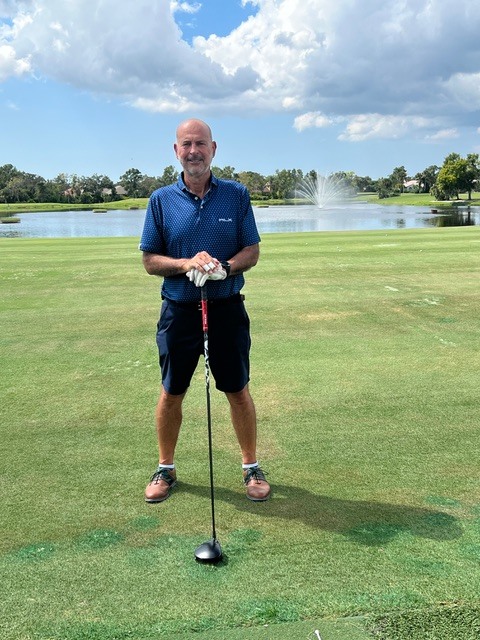 Mauricio on a Florida golf course, blue polo, driver in hand